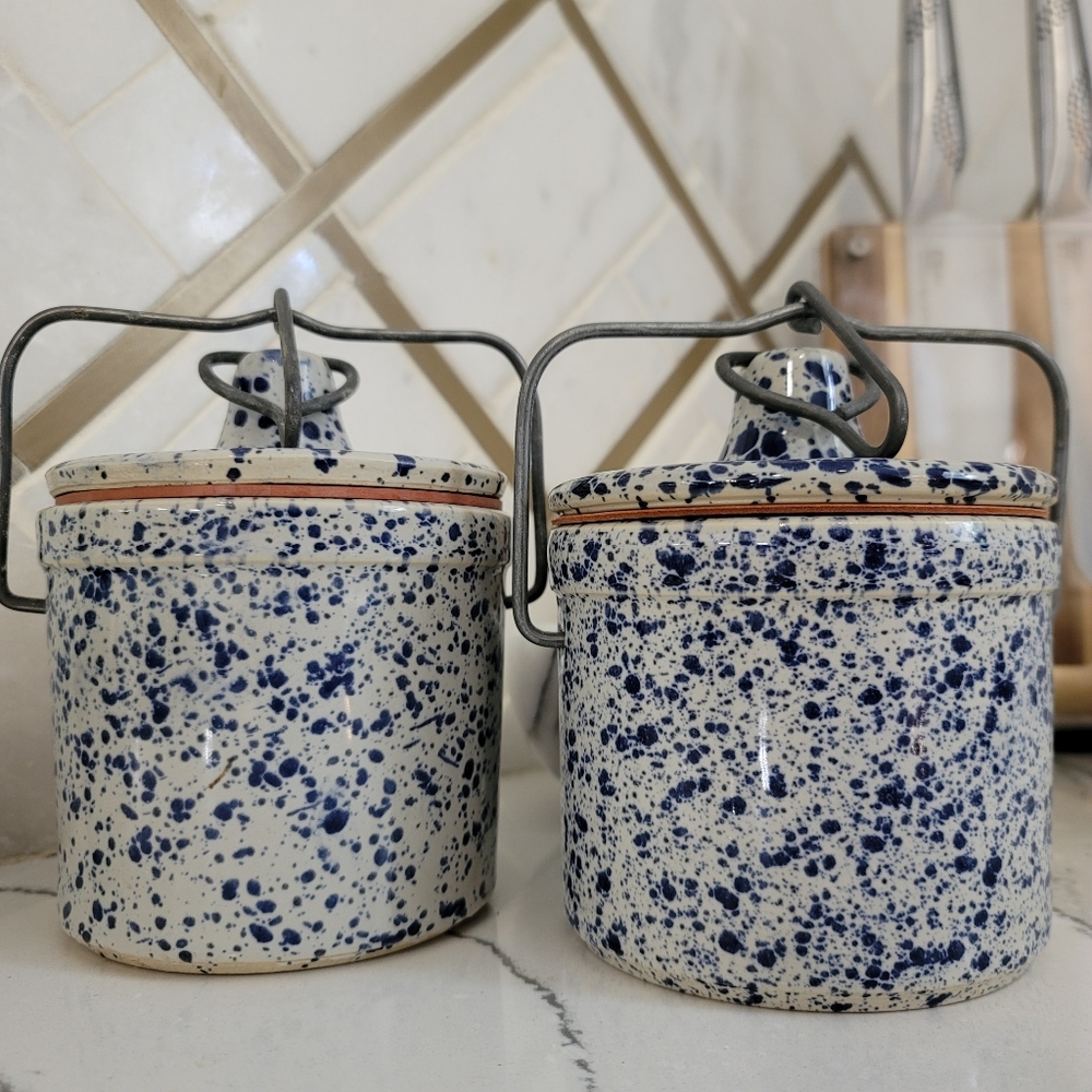 Blue and white ceramic cheese crocks with lids.